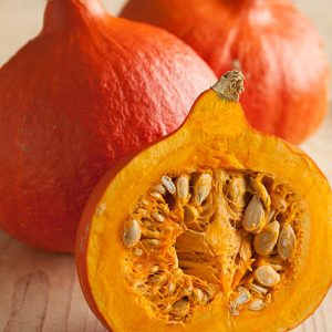 Fresh ripe orange whole and half hokkaido pumpkin